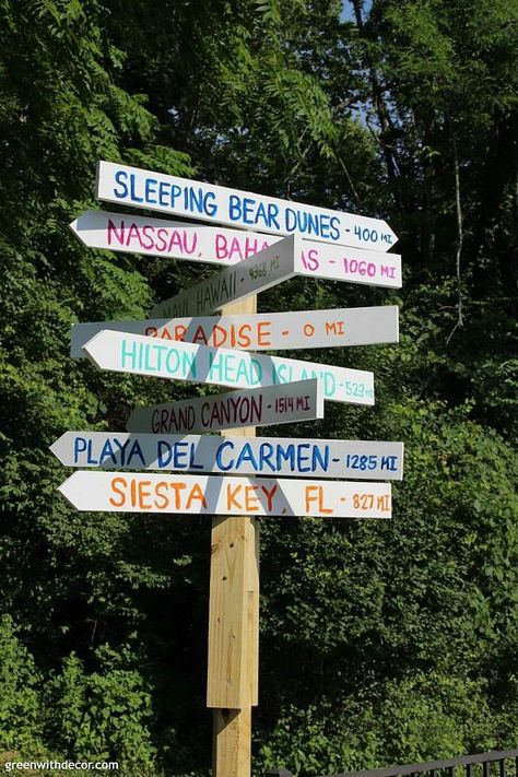 How to make a destination arrow sign so you can remember all of your fabulous vacations. A fun DIY project with a saw and some paint! LOVE THIS! #greenwithdecor #woodworking #arrowsign Destination Sign Post Diy, Destination Arrow Sign, Sign Post Ideas, Backyard Wood Projects, Nautical Landscaping, Destination Signs, Travel Signs, Wooden Arrow Sign, Direction Signs