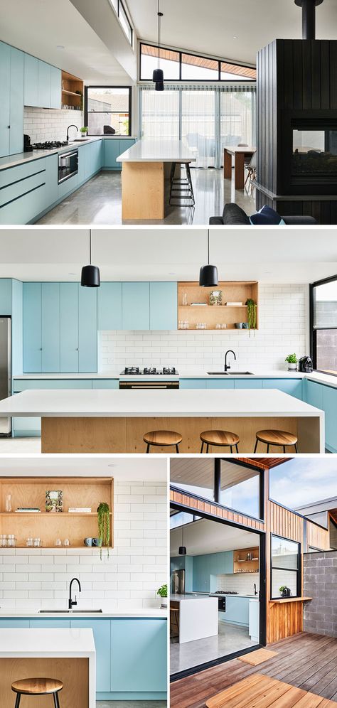 In this modern kitchen, matte light blue cabinets are paired with a white tile backsplash, plywood open shelves and island, and light Caesarstone countertops. #KitchenDesign #ModernKitchen #BlueKitchen Modern Light Blue Kitchen, Light Blue Modern Kitchen, Light Blue And Wood Kitchen, Light Blue House Interior, Blue And Wood Interior, Wood And Blue Kitchen, Modern Kitchen Design Blue, Light Blue Interior Design, Blue And Wood Kitchen