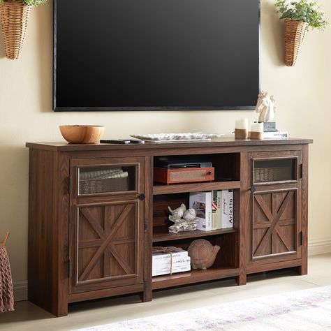 PRICES MAY VARY. FARMHOUSE STYLE TV STAND: Our 66-inch TV stand is designed in a style that blends farmhouse elements with a modern look, using a combination of vintage traditional flush doors and modern clear glass decor, with an overall structure of sleek lines for a beautifully atmospheric look. Smooth lines and a neutral colour scheme add a stylish touch to the rustic farmhouse. SPACIOUS TABLETOP: Measuring a 66"*16" roomy tabletop suitable for up to 75 inch television. There's plenty of room for family photos, potted plants and other decorations without being cramped. With a 1.18" thickened desktop that can hold 150 pounds and an overall use of premium engineered wood, this TV Console can withstand the challenges of long-term use. HUGE STORAGE SPACE: The overall 66"W x 16"D x 26"H hug Farmhouse Tv Stand Decor, 75 Inch Tv, Rustic Tv Console, Entertainment Center With Storage, Credenza Wood, Tv Console Cabinet, Farmhouse Entertainment Center, Farmhouse Tv, Modern Tv Cabinet