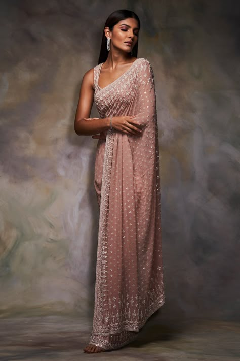 Peach saree with all-over sequin worked motifs and chevron pattern border. Comes with embroidered blouse. Components:2 Embroidered Neckline:V Neck Sleeve Length:Sleeveless Fabric:Georgette Color:Peach Tassel tie-up back - Aza Fashions Peach Georgette Saree, Seema Gujral, Sequins Saree, Peach Saree, Motif Embroidery, Sequin Saree, Perfect Peach, Gaun Fashion, Sequin Blouse