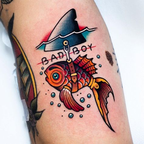 Out of Step Books & Gallery on Instagram: “Check out this awesome #badboy #goldfish #shark #tattoo that @miguelcomintattooer at @nolandtattooparlour created and who has all kinds of…” Small Traditional Tattoos For Men, Vibrant Traditional Tattoo, Quirky American Traditional Tattoos, Old School Tattoo Design Traditional Styles Flash Art, New Skool Tattoo Design, Cowboy Shrimp Tattoo, Traditional Florida Tattoo, Traditional Style Animal Tattoos, New School Tattoo Designs For Men