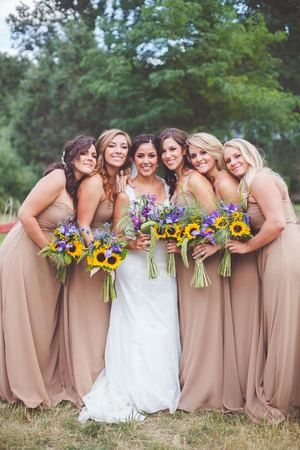 These fall bridesmaids wore floor-length sand colored gowns -- the pop of color from their sunflower and wildflower bouquets added the perfect autumnal touch! | 20 Fall Bridesmaid Dresses We Love {Alicia Lucia Photography} Bridesmaid Dresses Sunflower, Sunflower Wedding Bridesmaid, Gold Bridesmaids Dresses, Dresses Sunflower, Tan Bridesmaids, Fall Bridesmaid, Fall Bridesmaids, Sunflower Themed Wedding, Fall Bridesmaid Dresses