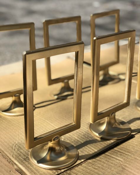 DIY Gold Table Number Holders Using $0.99 Ikea Tolsby Frames – angelahums Diy Gold Table, Diy Table Number Stands, Gold Table Number Holders, Diy Kallax, Ikea Tolsby Frame, Gold Table Number, Framed Table Numbers, Table Numbers Wedding Diy, Gold Table Numbers Wedding