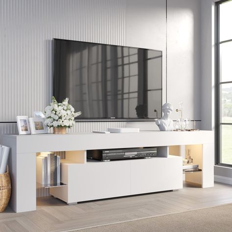 Orren Ellis Manjesh TV Stand for TVs up to 70" & Reviews | Wayfair https://www.wayfair.com/furniture/pdp/orren-ellis-manjesh-tv-stand-for-tvs-up-to-70-w011406592.html?piid=633386164 Stand For Tv, Tv Stand With Led Lights, White Tv Stands, Led Tv Stand, Drawers And Shelves, Modern Entertainment Center, Tv Console Table, Console Storage, Tempered Glass Shelves