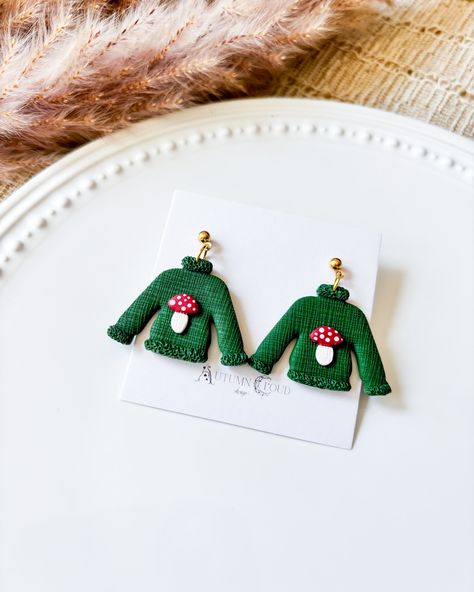 We are live! Check out our newest launch! #spookyseason #spookyszn #halloweenvibes #halloweenearrings #fallvibes #cuteearrings #polymerclay #polymerclayartist #clayartist #earringsforsale #witchyvibes #witchyearrings #handmadewithlove #smallbusiness #autumnvibes Textured Sweatshirt, Sweater Earrings, Mushroom Sweater, Clay Christmas, Polymer Clay Christmas, Textured Sweater, Halloween Earrings, Long Periods, Trinket Dishes