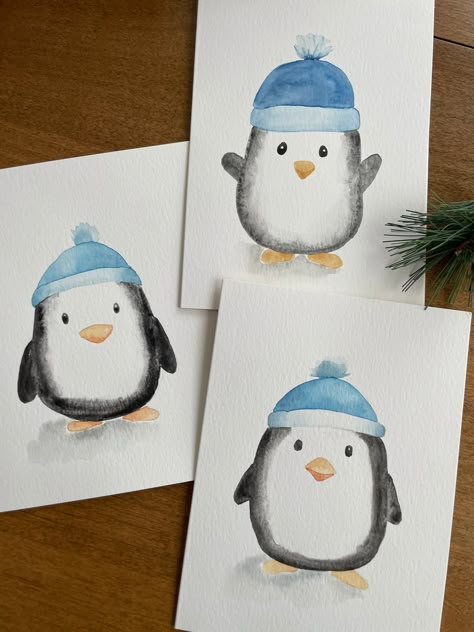 Description: Bring a touch of charm to your holiday greetings with this adorable winter penguin watercolor card! This 5x7 card features a hand-painted watercolor illustration of a cute penguin wearing a cozy blue hat, making it perfect for spreading warmth and joy during the holidays. Key Features: ❄️Original Watercolor Art: Each card showcases a unique, hand-painted winter penguin, ensuring that no two cards are exactly alike. ❄️Perfect for the Holidays: Ideal for Christmas, winter celebrations, or any festive occasion. ❄️Blank Inside: Plenty of space for your personalized message, making it suitable for various occasions. ❄️Quality Materials: Made with premium Strathmore watercolor paper for a beautiful and lasting finish. ❄️ White Envelope Included: Comes with a high-quality white envel Cute Christmas Cards Watercolor, Christmas Card Designs Watercolour, Christmas Cards Handmade Watercolor Simple, Watercolor Holiday Art, Watercolor Christmas Gifts, Winter Cards Diy, Hand Painted Christmas Cards Ideas, Simple Painted Christmas Cards, Watercolor Card Christmas