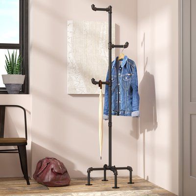 Williston Forge A factory-chic update on a classic foyer staple, this industrial coat rack lends eclectic appeal to any entryway or mudroom! Crafted of metal in an antique black finish, this pipe-inspired design measures just over 16" H x 19" W x 19" D and features distressed copper elbow joints for an antiqued appearance. Three coat hooks with elbow joint ends offer plenty of space to hang jackets, totes, and umbrellas, while four-pipe legs with flat round feet provide free-standing support. Classic Foyer, Diy Trinkets, Pipe Clothes Rack, Industrial Coat Rack, Diy Coat Rack, Hanger Stand, Standing Coat Rack, Pipe Furniture, Diy Greenhouse