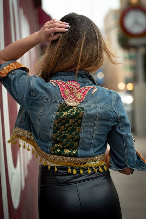 "This denim jacket named \" Delylah\" represents the free nature and spirit in us.The love for spontaniety and free will.The acknowledgement of bohemian in all of us.This is a beautiful ensemble handmade by rich and  luxurious pure \"banarsi\" fabric and vintage applique patch from India and Pakistan.The tassel fringe adds movement and flow to the piece. Its the one and only piece which you can order to exact size and color prefernces.As its a custom handmde piece it can be personalised further Navratri Denim Jacket Design, Vintage Denim Jacket Outfit, Coachella Jacket, Banarsi Fabric, Boho Jean Jacket, Boho Denim Jacket, Denim Jacket Embroidery, Garba Outfit, Applique Jacket