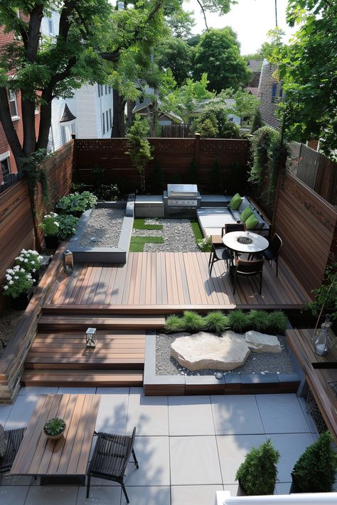 Modern backyard with wooden decking, seating area with green cushions, dining table, grill, and lush landscaping featuring trees and plants. Garden Contemporary Design, Patio Design Architecture, Paving And Decking Together, Backyard Exterior Design, Outside Landscape Ideas, Modern Backyard Patio Designs, Modern Deck Design Backyards, Modern Terraced Landscaping, Small Deck Designs Backyard