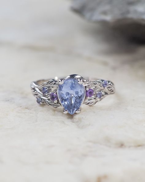 READY TO SHIP 1-4 BUSINESS DAYS! 14K white gold, natural blue sapphire, accent amethysts & tanzanites, AVAILABLE RING SIZES 5.5 - 8.5 US Delicately sculpted, this bridal set would be perfect for alternative engagement ring seekers. You can see Japanese maple leaves wrapping the central gemstone - natural blue sapphire. Adorned with accent purple amethysts & blue tanzanites. Details Central gemstone: natural blue sapphire, pear-cut, 8.5x6mm, *1.8ct Accent gemstones: natural purple amethysts & natural blue tanzanites 14K white gold Shop this style with different options: Japanese Maple Feel free to request your unique gemstone combination, we'll be happy to customise this ring for you. E-mail for inquiries: edengardenshop@gmail.com Japanese Maple Leaves, Sapphire Bridal Set, Alternative Engagement Ring, Gold Shop, Japanese Maple, Yellow Shop, Alternative Engagement Rings, Maple Leaves, Rose Yellow