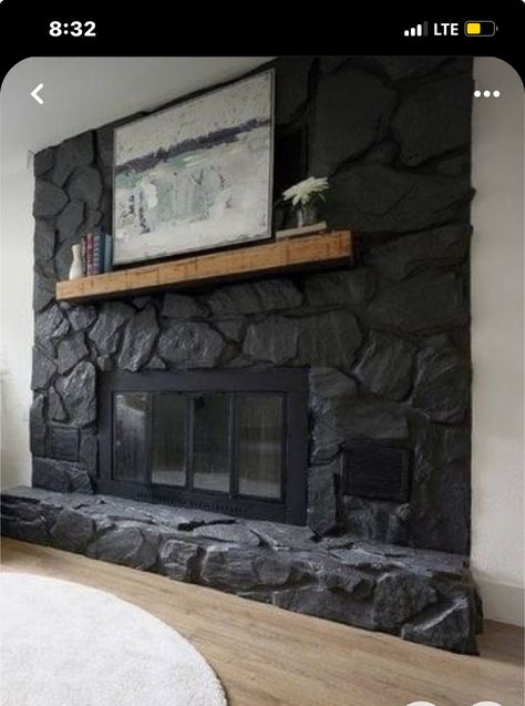 Black Rock Wall Fireplace, Black Stone Corner Fireplace, Dark Wash Fireplace, Grey Painted Rock Fireplace, Rock Chimney Makeover, Black Stone Fireplace Modern, White Stone Fireplace With Black Mantle, Fireplace Makeover Concrete, Rock Fireplace Remodel