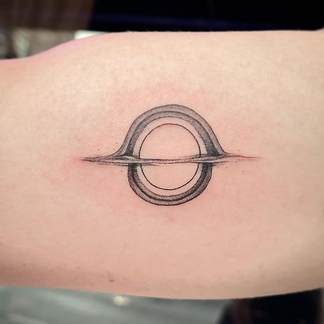 This tattoo is out of this world 🌌👽 My little brother has always been a huge fan of the movie Interstellar, so when I got the honor of giving him his first tattoo yesterday, we came up with this sick black hole design!! Thanks for the trust John, you're a champ :) #tattoo#tattooartist#tattooapprentice#apprenticetattoo#art#artist#blackandgreytattoo#stippletattoo#stippling#3rl#fineline#finelinetattoo#spacetattoo#outerspace#blackhole#interstellar#outofthisworld#customdesign#flashtattoo#linework The Expanse Tattoo, Expanse Tattoo, Blackhole Interstellar, Black Hole Design, Interstellar Tattoo, Little Brother, Stippling, First Tattoo, Interstellar