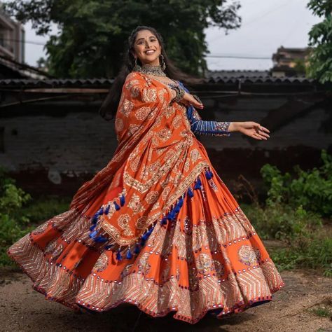 25+ Lehenga Choli Designs To Jazz Up Navratri Garba Night - ShaadiWish Orange Chaniya Choli For Navratri, Orange Lehenga For Navratri, घाघरा चोली, Bandhej Lehenga, Orange Butter, Garba Outfit, Navratri Garba, Navratri Collection, Mirror Work Lehenga