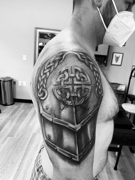 Shoulder tattoo, black and gray realistic armor tattoo, celtic, shield Arm Shield Tattoo, Shoulder Shield Tattoo For Men, Dragon Shield Tattoo, Celtic Shoulder Tattoo Men, Celtic Shield Knot Tattoo, Armor Tattoo Stencil, Shield Tattoos For Men, Celtic Armor Tattoo, Armour Tattoo Design