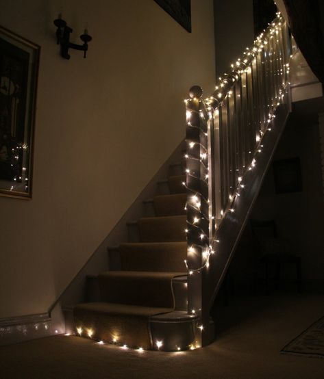 Staircase Fairy Lights: Using LED Christmas Lights Around the Home - Fairy Lights & Fun Fairy Light Staircase, Christmas Lights On Stairs Railings, Christmas Lights On Staircase, Stair Railing Decor, Fairycore House, Uni House, Fairy Lighting, Fairy Lights Garden, Fur Chair