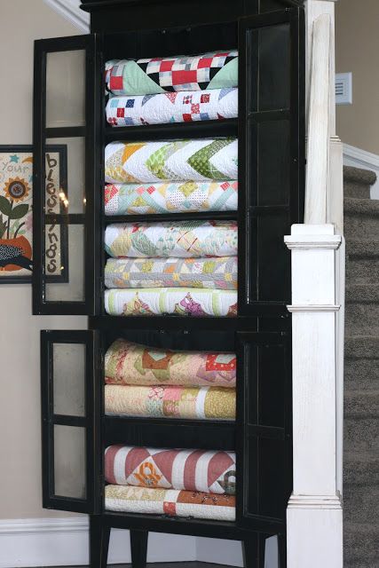 In each of these quilts there is about 2 or 3 smaller quilts stuffed inside them.  I like that you can see more of each quilt now. Sew Kind Of Wonderful, Quilt Display, Quilt Rack, Black Cabinet, Quilt Storage, Quilting Room, Blanket Storage, Sewing Rooms, Beautiful Quilts