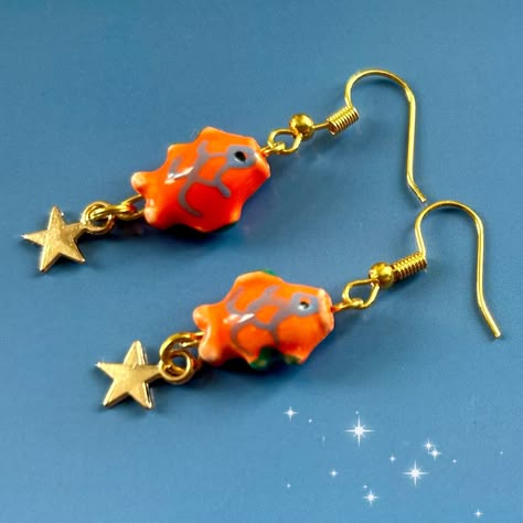 Japanese painted bead gold  koi fish earrings. Unique to my shop! Cute mini ceramic bead koi fish carp star earrings. The koi fish has long been known as a lucky symbol of good fortune.  These earrings feature a unique design that is my own design making them a one-of-a-kind gift for your loved ones. The cute ceramic fish on the earrings are seen swimming upstream against the current, symbolizing perseverance and strength.  Measuring at 1.5cm x 1 cm the charm size is perfect for making a splash Cute Japanese Accessories, Clay Fish Earrings, Gold Koi Fish, Gold Koi, Japanese Earrings, Funky Accessories, Family Peace, Fish Beads, Fish Earrings