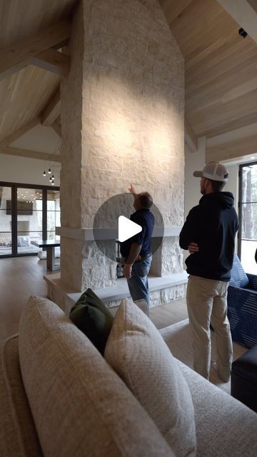 Hendel Homes on Instagram: "Talking with one of our knowledgeable site supervisors on the background behind this custom designed fireplace. Walking into the great room, this feature certainly draws your eye in as you step into the space. Properly executed with quality by @lukebuskermasonry @orijinstone and @glowing_hearth. A limestone feature we love that compliments both the exterior and interior!" Fireplace Bench Ideas, Indoor Stone Fireplace, Stone Fireplaces Floor To Ceiling, Limestone Fireplace Wall, Fireplace In The Middle Of The Room, Fireplace Build Out, Fireplace In Middle Of Room, Rock Fireplace Ideas, Limestone Wall Interior