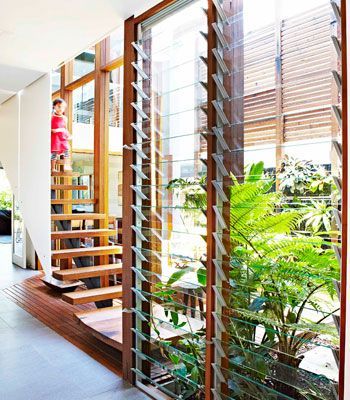 Light and air A long hallway connects the two parts of the house. Here, louvred windows from Stockwells Joinery keep the area well ventilated. The stair treads are made from recycled timber from Ironwood. ECO TIP Louvred windows are great for passive cooling. Up high, they let hot air out while down low they let cool air in. To keep warm in winter, make sure they seal properly to keep out draughts.: Jalousie Window, Louvre Windows, Tropical House Design, Passive Cooling, Louver Windows, Renovation Diy, Rest House, Long Hallway, Tropical House