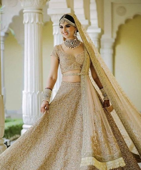 Simple yet elegant beige bridal lehenga for wedding.  #bridallehenga #metalliclehenga #weddingwear #weddingoutfit #bridaloutfit #bridalwear #brides2019 #heavylehenga #elegantlehenga #shaadisaga Golden Bridal Lehenga, Manish Malhotra Lehenga, भारतीय दुल्हन संबंधी, Golden Lehenga, Brown Clothes, डिजाइनर कपड़े, Pengantin India, Bridal Lehenga Designs, Latest Bridal Lehenga