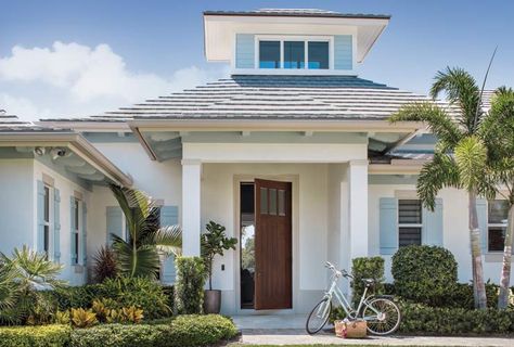 Krista   Home Designs A Comfortable Juno Beach Waterfront Home Margaritaville Parrot, Brick Paint Colors, Coastal Houses, White Exterior Paint, Florida Beach House, Palmer House, Porch Styles, Blue Shutters, Beach House Interior Design