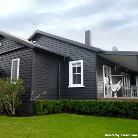 The weatherboards of the transitional bungalow were stripped back and painted in semi-gloss Resene Sonyx 101 tinted to Resene Double Foundry. The windows and tr... White Weatherboard House, Charcoal House, White Window Trim, Lifestyle Block, Old House Exterior, Best Exterior House Paint, Exterior Paint Schemes, 1920s Bungalow, Weatherboard House