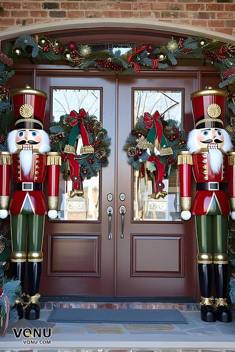 Festive front door decor featuring two majestic nutcracker statues, wreaths with red bows, and lush garlands adorned with ornaments. Nutcracker Christmas Door Decorations, Front Porch Christmas Decor Nutcracker, Nutcracker Outdoor Decor Christmas Yard, Outdoor Christmas Decorations Nutcracker, Christmas Nut Cracker, Nutcracker Themed Christmas Decor Ideas, Nutcracker Front Porch, Elegant Outdoor Christmas Decor, Christmas Nutcracker Decor