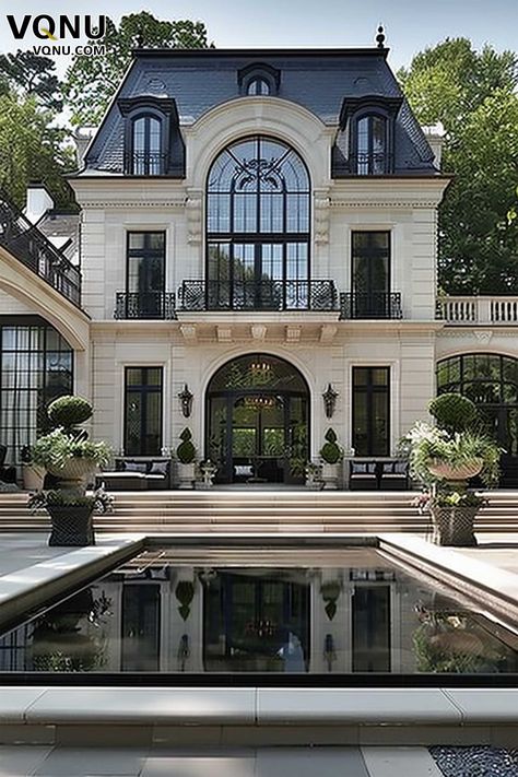 A stately French manor with a grand facade featuring intricate architectural details, elegant balconies, and a serene reflecting pool in the courtyard, embodying luxury and sophistication. French Facade Architecture, South Of France Mansion, European Pool Landscape, Elegant House Exterior Luxury, French Inspired Home Exterior, French Villa Exterior, Modern French House Design, French Modern Home Exterior, Modern French Homes