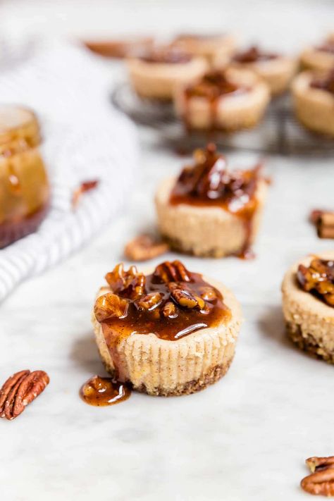 These mini pecan pie cheesecakes are gluten-free and grain-free with a spiced pecan crust and topped with a decadent pecan pie caramel sauce. Perfect for holiday entertaining! They're easy to make ahead and a delicious dessert for any party, whether you're hosting or bringing a dish to share. Skip the graham crackers and go with a pecan crust for these easy mini cheesecakes spiced with cinnamon. #glutenfree #entertaining #grainfree Easy Mini Cheesecakes, Mini Pecan Pie, Mini Cheesecakes Easy, Individual Cheesecakes, Pecan Crust, Mini Pecan Pies, Pecan Pie Cheesecake, Mini Cheesecakes, Great Desserts