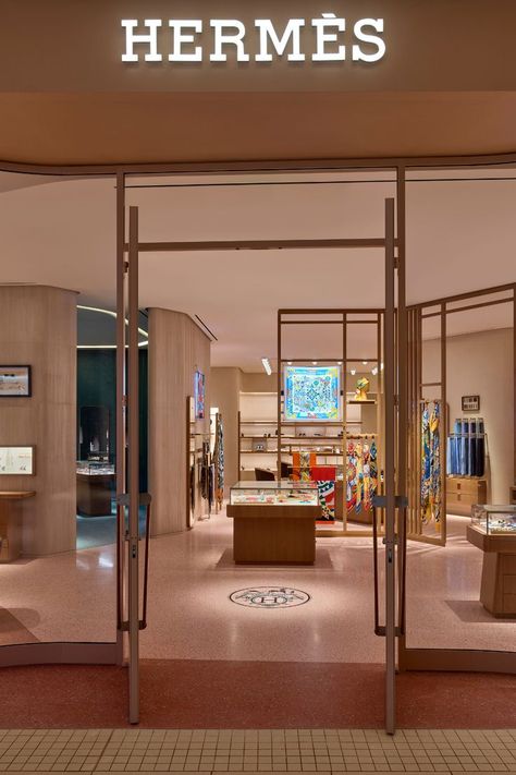 The new Hermès store at Aventura Mall fuses Miami’s unique coastal atmosphere with the luxury fashion house’s French spirit. Customers enter the store through an undulating glass façade, reminiscent of the waves of the sea and framed in metal in a warm shade of pink. Across the threshold, discover all 20 product categories such as leather goods, fine silk scarves, ties, men and women’s ready-to-wear collections, jewelry, fragrance, Art de Vivre, and Art de Table. Visit Hermès at Aventura Mall. Aventura Mall, Hermes Store, Hermes Shop, Mall Stores, Store Layout, Glass Facades, Store Design Interior, Store Interior, Shop Interiors