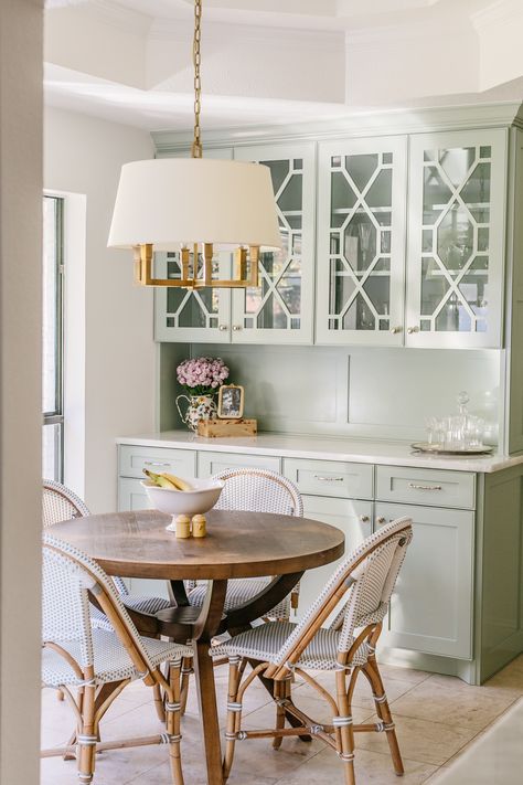 This home feels like stepping into a coastal grandmother's heaven. It includes true traditional details and materials - brass, woven textures, linen,  florals, etc. We love the cafe chairs and additional glass front cabinetry to store china, vases, etc.

Traditional Home, Coastal Grandmother, Grandmillennial, Traditional Style, Home Inspiration, Kitchen Inspo, Breakfast Nook, Charming Kitchen Breakfast Room Cabinets, Breakfast Nook Cabinets, Breakfast Nook Art, Traditional Breakfast Nook, Breakfast Nook Light Fixture, Feminine Farmhouse, Carpenter House, Breakfast Nook Lighting, Cozy Breakfast Nook