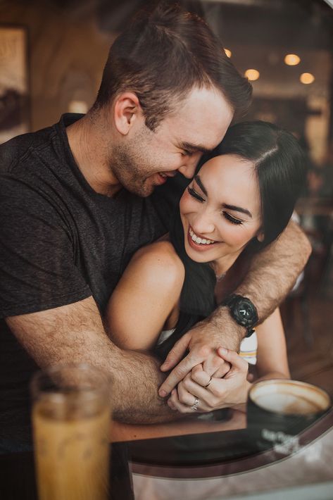 Cute couple posing for a photoshoot in a coffee shop where they fell in love. Engagement photos in a coffee shop. Coffeeshop Photoshoot Couple, Coffee Shop Engagement Photoshoot, Coffee Shop Date Photoshoot, Coffee Shop Maternity Shoot, Coffee Couple Photography, Coffee Couple Aesthetic, Engagement Photos Coffee Shop, Coffee Shop Couple Photoshoot, Coffee Shop Engagement Photos