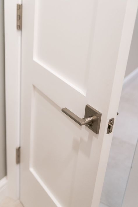 The modern square backplate and handle of this door lever work beautifully with the more traditional shaker panel door. Modern Door Trim, Brushed Nickel Door Knobs, Brushed Nickel Door Handles, White Interior Doors, Condo Renovation, Door Handle Design, Sutton Place, Shaker Doors, Panel Door