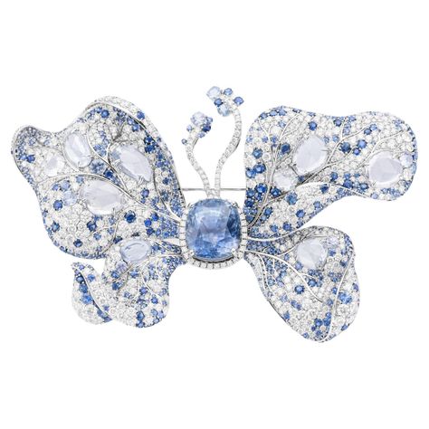 At its heart lies a stunning 12.01 carat cabochon-cut natural blue sapphire, set in 18 carat White Gold. The butterfly's delicate wings sparkle with a constellation of diamond and sapphire melee, creating a dazzling interplay of light and colour. More than just beautiful, this brooch is a masterpiece of craftsmanship, featuring a curved pin and pull-out clasp for secure and comfortable wear. Whether pinned to a lapel or gracing an evening gown, this sapphire and diamond butterfly is sure to capt Diamond Dress Ring, Diamond Butterfly, Butterfly Style, Emerald Pendant, Beautiful House, Butterfly Brooch, Gold Brooches, Green Diamond, Champagne Diamond