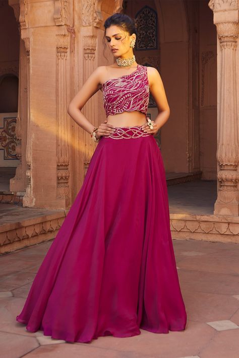 Raspberry lehenga with cutdana and sequin embellishment at the waistband. Comes with one shoulder blouse. Component: 2 Embellished Neckline: Asymmetrical Sleeve Length: Sleeveless Fabric: Blouse- Tussar Silk, Lehenga- Net Color: Pink Blouse with scallop hemline Closure: Side zip - Aza Fashions Chaniya Blouse, Lehenga With Crop Top, Outfit Bridesmaid, Embellished Lehenga, Glamour Clothing, Ruffled Saree, Stylish Kurta, Green Anarkali, Floral Embroidered Shirt