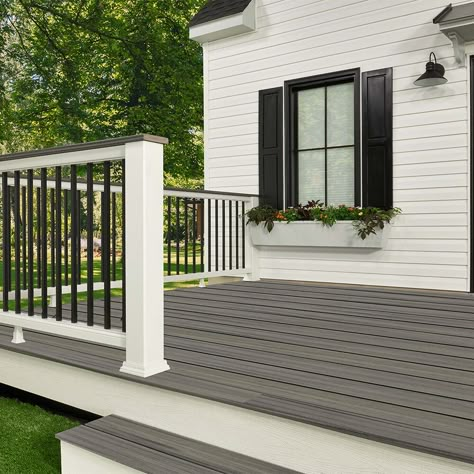 The Trex composite railing post sleeve fits over a 4 x 4 pressure-treated post or a post surface mount. This Trex railing component is made of a high-performance composite material that won't warp, rot, split or splinter. Cleans easily with soap and water. Backed by a 25-Year Limited Residential Warranty. Decking and Railing Duos offer a simplified approach to deck design. Trex railings are designed to meet national building code requirements for residential and commercial dwellings. Trex produc Outside Decks And Patios Ideas, Front Porch Railing Designs, Gray Trex Deck Ideas, Patio With Steps Down From House, Trex Front Porch, Trex Deck Ideas, Trex Porch, Trex Deck Railing, Simple Deck Designs