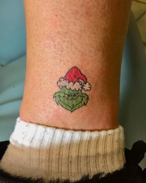 Small Winter Tattoo Ideas, Small Grinch Tattoo, Cute Christmas Tattoos, Christmas Theme Tattoo, A Christmas Story Tattoo, Grinch Tattoo Design, Grinch Tattoo Ideas Small, Small Christmas Tattoos, The Grinch Tattoo