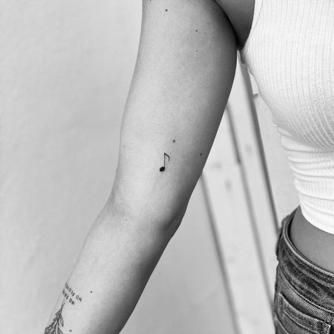 Minimalist music note tattoo on the inner arm Ear Tattoo Inner Music Notes, Half Note Tattoo, Quarter Note Tattoo, Music Note Tattoo Ankle, Music Note Fine Line Tattoo, Ukulele Tattoo Small, Music Key Tattoo, Dainty Music Note Tattoo, Fine Line Music Note Tattoo