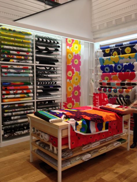 Marimekko fabric display Fabric Display Ideas Showroom, Fabric Shop Display, Fabric Store Displays, Fabric Store Design, Interior Design Fabric, Sewing Room Storage, Marimekko Fabric, Store Fabric, Sewing Room Decor