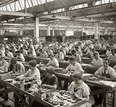 This photo shows workers at their stations in a factory. One can see the assigned parts, showing a vital component of the revolution: the assembly line, which allowed for rapid production. Frederick Taylor, Agricultural Revolution, Scientific Management, Office Word, Corporate America, Interpersonal Relationship, 100 Years Ago, Industrial Revolution, Cool Poses