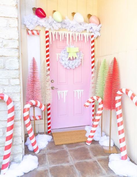 A pastel wonderland. Complete with fun pastels and giant candy canes and bulbs, this front door designed by Sam from Aww Sam is as inviting as it gets! House Door Decor, Gingerbread House Door, Christmas Door Decoration, Gingerbread Christmas Decor, Gingerbread House Decorations, House Door, Pink Christmas Decorations, Christmas Yard Decorations, Christmas Gingerbread House