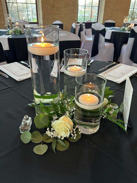 Vases of three different sizes used to create this centerpiece option. Floating candles placed in the water. So beautiful and elegant #2024bride #weddingideas #weddingcenterpiece #centerpieces #blackandwhite #blackandwhitewedding #amazon #amazonaffiliatelink #weddingideas Water Candles Floating Wedding, Glass Vases With Floating Candles, Cylinder Floating Candle Centerpieces, Three Vase Centerpiece Wedding, Three Vases Centerpiece, Candles In Water Centerpieces, Water Candles Floating, Floating Candles Wedding Centerpieces, Candle Water Centerpiece