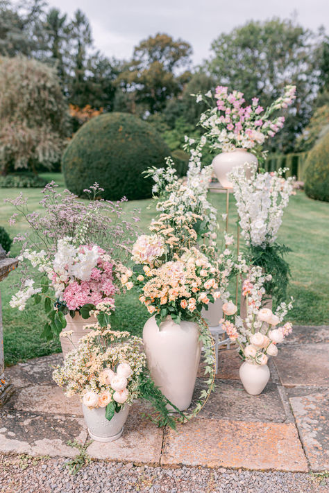 Modern Ceramic Vase Ceremony Backdrop #ceramicvase #weddingvases #weddingcenterpieces #weddingflowers #floralarrangements Modern Urn Flower Arrangements, Large White Vase With Flowers, Wedding Ceremony Urn Arrangements, Wedding Ceremony Vases, Cross Wedding Flowers, Romantic Garden Wedding Ceremony, Wedding Urns Ceremony, Wedding Flower Vases, Grounded Florals Wedding Ceremony