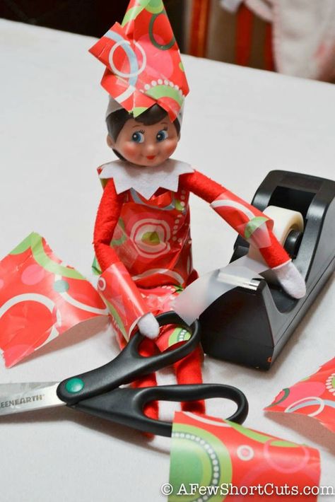 This Elf on the Shelf is all wrapped up in Christmas! http://afewshortcuts.com/2013/12/elf-on-the-shelf-all-wrapped-up/ Elf On The Shelves, Timmy Time, Shelf Elf, Awesome Elf On The Shelf Ideas, Elf Magic, Elf Activities, Xmas Elf, Elf Antics, Elf Fun