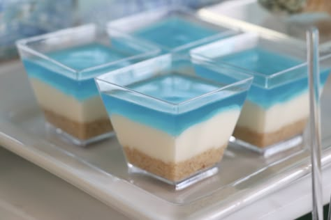 These white chocolate mousse cups with shortbread crumbs will make the perfect addition to any beach themed party! Beach Themed 40th Birthday Party, Coastal Beach Party Theme, Ocean Theme Deserts, Beach Themed 21st Birthday, Ocean Inspired Desserts, Beach Jello Cups, Beach Themed One Year Old Party, Disney Beach Party, Ocean Themed Brunch