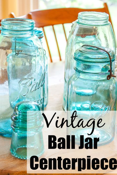 Vintage Ball Jar Centerpiece - Create a beautiful table centerpiece with vintage ball jars and insulators.  #vintagecenterpiece #vintageballjars #vintagemasonjars #masonjarideaas via @spaula Antique Mason Jars Decor, Blue Ball Jars Decorating With, Ball Jars Ideas, Mason Jar Centerpieces Table Decorations, Ball Jar Centerpieces, Blue Mason Jar Centerpieces, Canning Jar Centerpieces, Country Table Centerpieces, Oui Jars