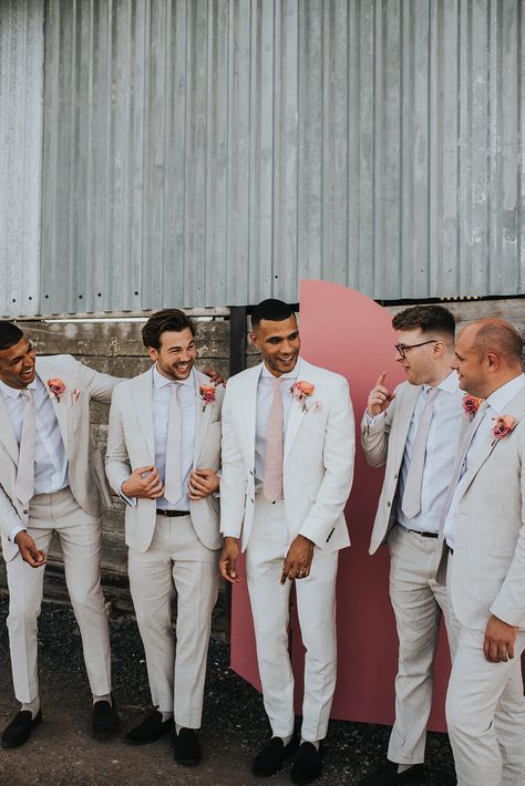 Groom Tux Spring Wedding, Pink And Yellow Groomsmen, Spring Groom And Groomsmen Attire, Light Pink Tuxedo Wedding, Colored Grooms Suits, Pastel Wedding Tuxedo, May Wedding Groom Attire, Peach Wedding Suit, August Groomsmen Attire