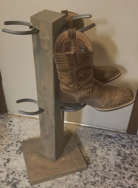 A boot tree to hold up to 4 pairs of boots! A space saver only taking up 1 square foot of floor space! Real horseshoes used to hold your boot straps. Boot Rack For Cheyenne Local Deliveries Please contact Seller** To view color options, please visit: https://www.thehatrackguy.com/gallery 26" tall 11" Floor Space Cowboy Boot Rack, Horseshoe Boot Rack, Boot Hanger, Cowboy Hat Rack, Boot Holder, Welding Design, Boot Organization, Boot Tree, Horseshoe Projects