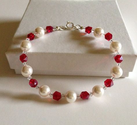 "Pearl bracelet, This is a beautiful swarovski pearl and crystal beaded bracelet the pearls are 8mm in size and are white in color, the crystals are a ruby red with a tiny clear crystal on either side of each ruby red crystal, this one has the sparkle factor without being overwhelming. the bracelet will fit up to a 7 and 1/4\" wrist. The bracelet is finished with sterling silver clasp, guardians and silver beads. Images may appear larger than actual size to show detail." White And Red Bracelets, Red Pearl Bracelet, Red Beads Bracelet, Collares Aesthetic, Red Bead Bracelet, Red Beaded Bracelet, Red Bracelet, Diy Jewelry Unique, Beaded Necklace Diy