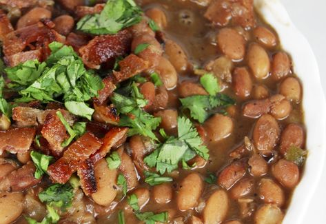 Here is a delicious bean dish I absolutely adore. It’s from Rick Bayless. I have all his cookbooks. I love how he makes authentic Mexican food so accessible. Don’t get me wrong, I love gringo style Mexican food a ton, but sometimes I crave the real deal. Whenever I want the real thing, I immediately … Mexican Beans, Charro Beans, Mexican Food Recipes Authentic, Veggie Sides, Mexican Dishes, A Bowl, Soups And Stews, Cilantro, Guacamole